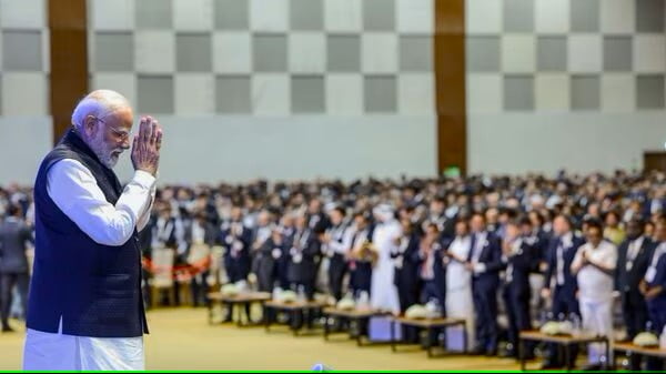 rime Minister Narendra Modi gestures to dignitaries while attending the Vibrant Gujarat Summit 2024, at Mahatma Mandir in Gandhinagar on Wednesday (ANI)